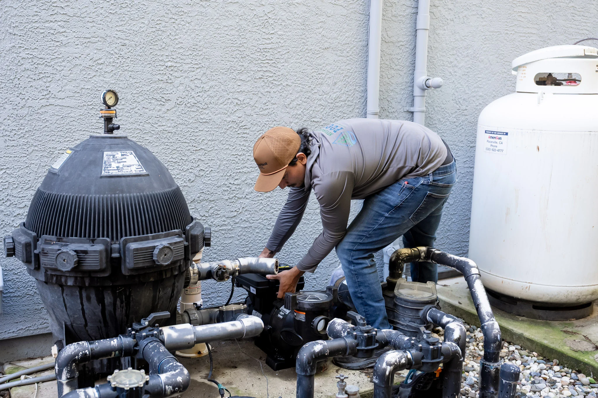 Beyond Pool Cleaning technician servicing a pool filter system in Scottsdale