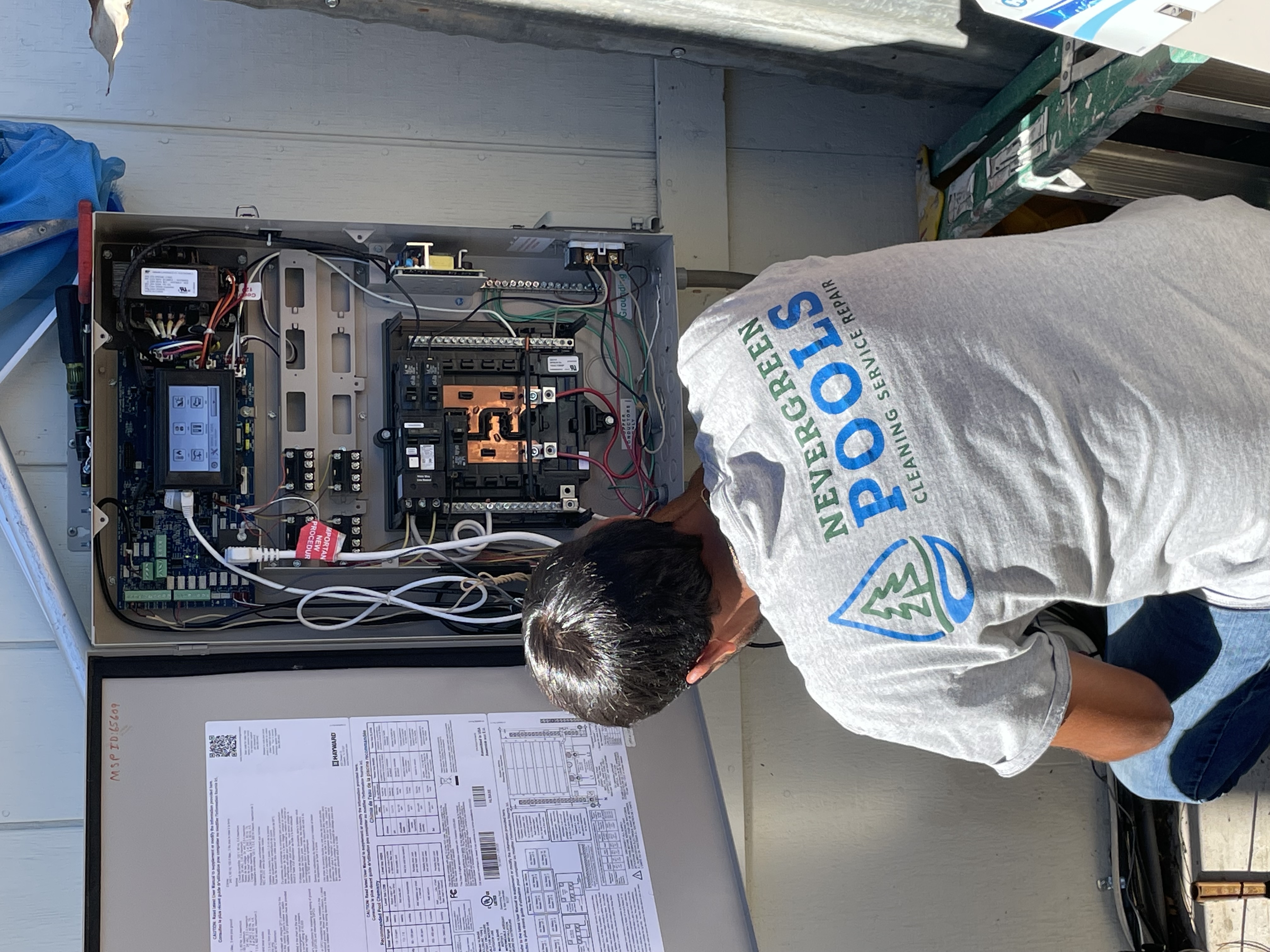 Beyond Pool Cleaning tech inspecting pool equipment